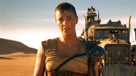 Imperator Furiosa standing beside a dust-scarred rig